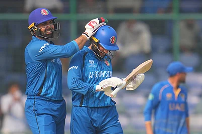| Photo: AP/Manish Swarup : Afghanistans Mohammad Nabi congratulate teammate Afghanistans Azmatullah Omarzai after wining against United Arab Emirates during the T20 World Cup cricket match in New Delhi.