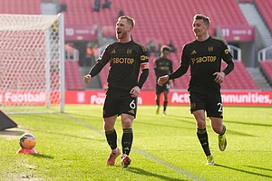 | Photo: Nick Potts/PA via AP : Fulham's Harrison Reed, left, celebrates with Timothy Castagne after scoring his sides second goal during the English FA Cup fourth round match between Stoke City and Fulham, in Stoke, England.