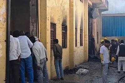 | Photo: Handout via PTI : Firefighters and locals at a chemical factory building after a fire broke out at the premises, in the Khushkhera-Karouli Industrial Area of Bhiwadi, Rajasthan. Officials said seven workers were killed and two others were feared trapped after a fire broke out at the unit.