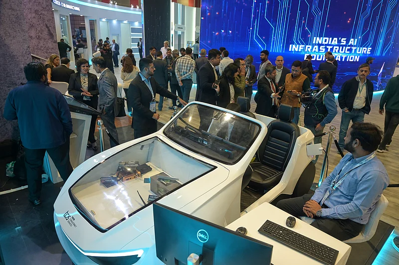 (AP Photo) : Delegates watch an exhibition on the use of AI during an AI-Summit in New Delhi, India, Monday, Feb. 16, 2026.