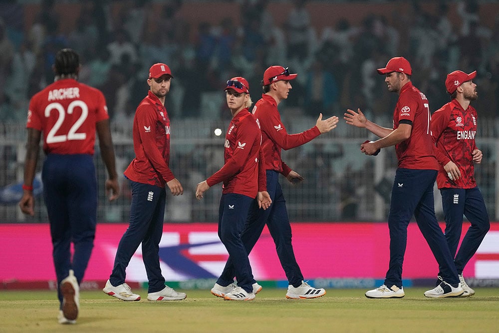 | Photo: AP/Bikas Das : Englands captain Harry Brook, centre, celebrates with teammates after winning the T20 World Cup cricket match against Italy in Kolkata, India.