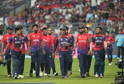 | Photo: AP/Rafiq Maqbool : Nepal cricket team walks back to the pavilion after defeating Scotland during the T20 World Cup cricket match in Mumbai.