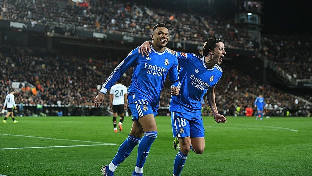| Photo: AP/Francisco Macia : Real Madrid's Kylian Mbappe, left, celebrates with Alvaro Carreras after scoring his side's second goal during the Spanish La Liga soccer match between Valencia and Real Madrid in Valencia, Spain.