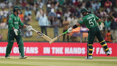Photo: AP : Pakistans Sahibzada Farhan, right, and Saim Ayub, left, bat during the T20 World Cup match between Namibia and Pakistan in Colombo.