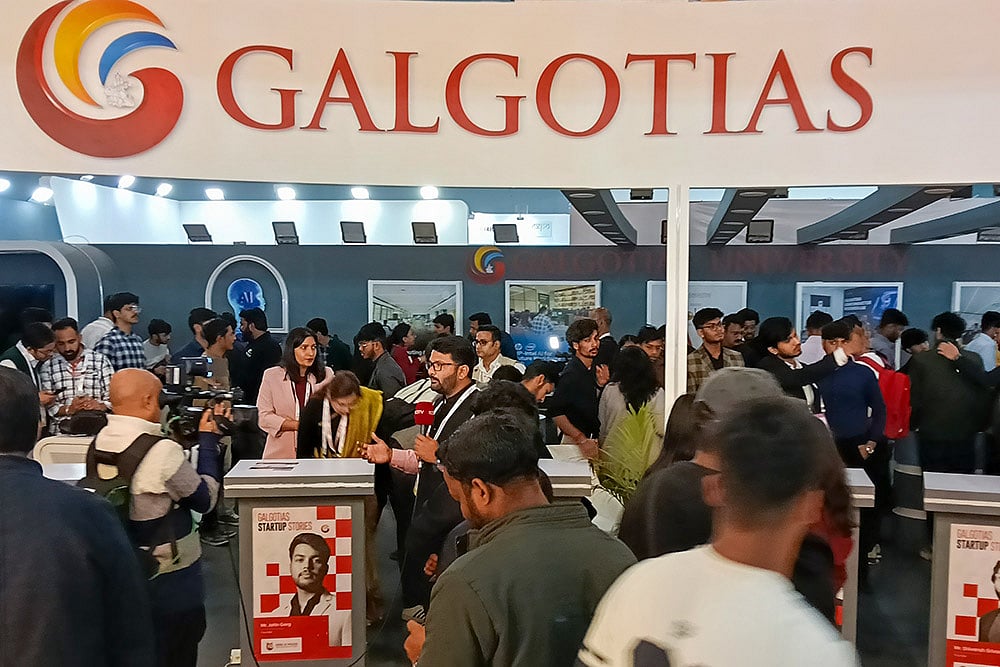 | Photo: PTI : Visitors at Galgotias Universitys stall during the India AI Impact Summit 2026, in New Delhi. The University has been asked to vacate its stall at the AI Summit Expo immediately, sources said on Wednesday, amid a controversy over the display of a robotic dog that raised questions about the origin and ownership of the technology showcased.