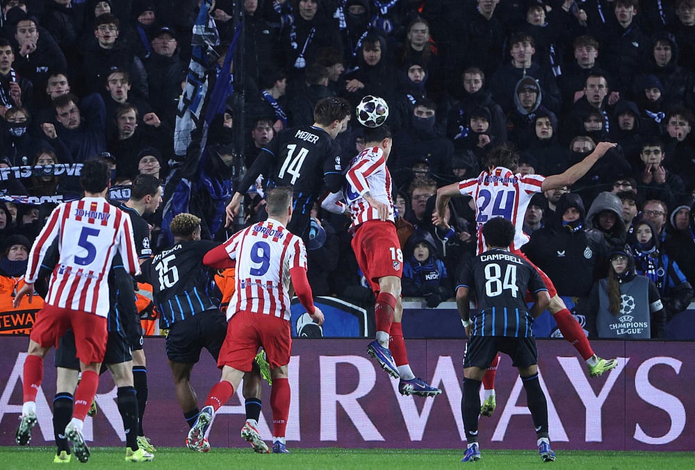 | Photo: AP/Omar Havana : Atletico Madrids Marc Pubill, centre right, and Brugges Bjorn Meijer, centre top, challenge for the ball during the Champions League play-off first leg soccer match between Club Brugge and Atletico Madrid, in Bruges, Belgium.