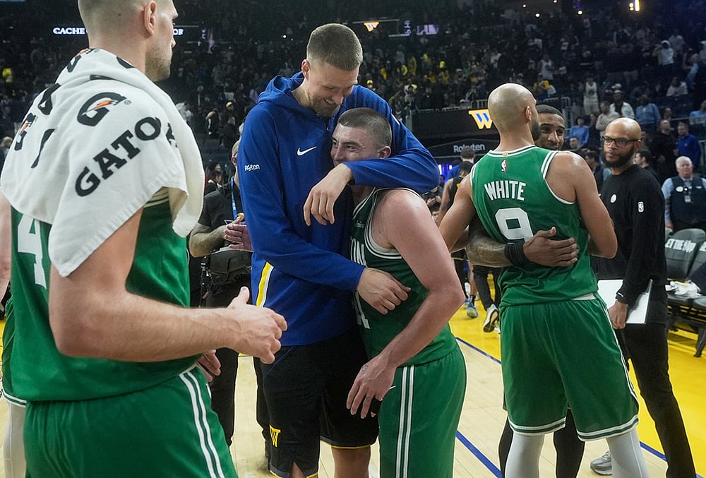 | Photo: AP/Jeff Chiu : Golden State Warriors center Kristaps Porziņģis, top middle, hugs Boston Celtics guard Payton Pritchard as Celtics guard Derrick White (9) hugs Warriors guard Gary Payton II after an NBA basketball game in San Francisco.
