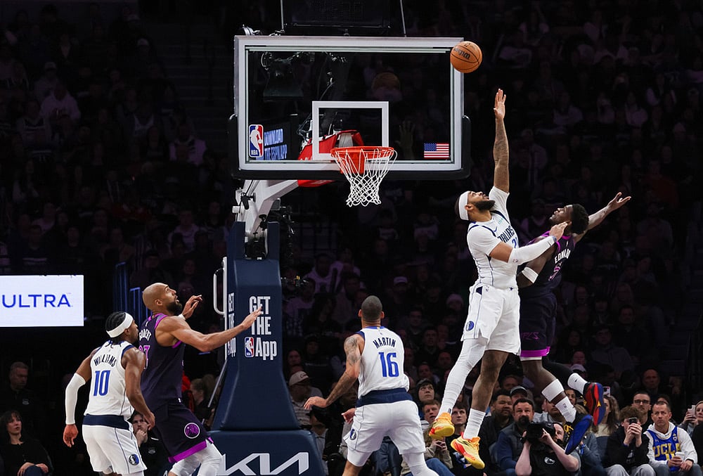 | Photo: AP/Lily Dozier : Dallas Mavericks Daniel Gafford, second from right, leaps to block a shot by Minnesota Timberwolves Anthony Edwards, right, during the second half of an NBA basketball game in Minneapolis. 
