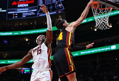 | Photo: AP/Colin Hubbard : Atlanta Hawks forward Corey Kispert, right, dunks against Miami Heat center Bam Adebayo, left, during the first half of an NBA basketball game, in Atlanta.