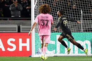 | Photo: AP/Jessie Alcheh : Los Angeles FC forward Denis Bouanga (99) celebrates after scoring a goal as Inter Miami defender Maximiliano Falcón (37) watches during the second half of an MLS soccer match in Los Angeles, Calif.