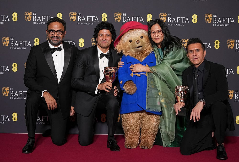 | Photo: AP/Alastair Grant : Alan McAlex, from left, Farhan Akhtar, Paddington Bear, Lakshmipriya Devi, and Ritesh Sidhwani pose with the award for childrens & family film for Boong at the 79th British Academy Film Awards, BAFTAs, in London.