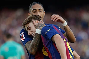 | Photo: AP/Joan Monfort : Barcelona's Raphinha hugs Fermin Lopez after a goal during a La Liga soccer match between Barcelona and Levante in Barcelona, Spain.