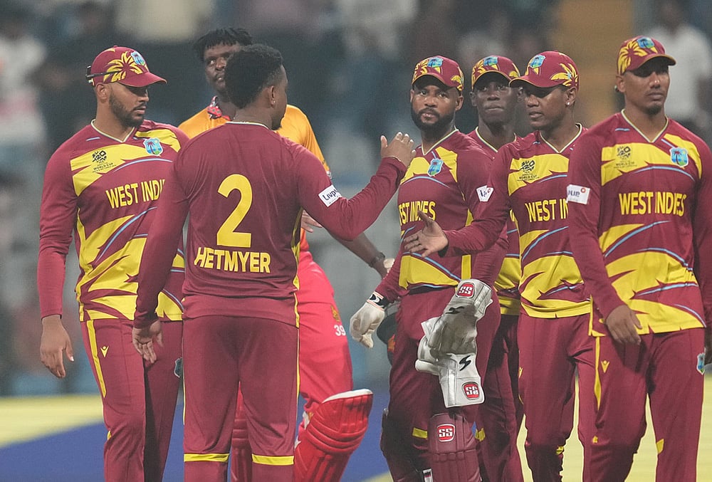 | Photo: AP/Rafiq Maqbool : West Indies Shimron Hetmyer, second from left, celebrates with teammates after their win against Zimbabwe during the T20 World Cup cricket match in Mumbai.