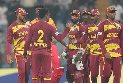 | Photo: AP/Rafiq Maqbool : West Indies Shimron Hetmyer, second from left, celebrates with teammates after their win against Zimbabwe during the T20 World Cup cricket match in Mumbai.