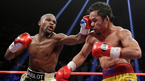 File/AP : Floyd Mayweather Jr., left, hits Manny Pacquiao, from the Philippines, during their welterweight title fight on May 2, 2015, in Las Vegas.