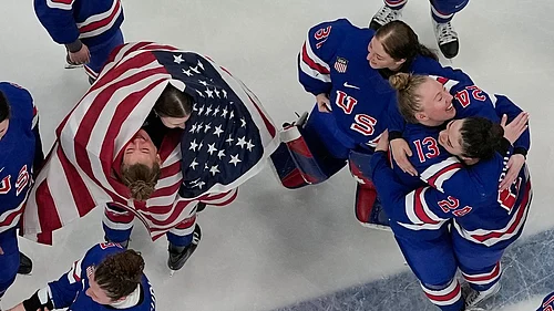 AP : Team United States players celebrate after beating Canada 2-1 in overtime in the womens ice hockey gold medal game at the 2026 Winter Olympics, in Milan.
