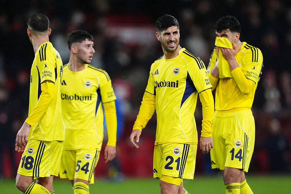 | Photo: Mike Egerton/PA via AP : Fenerbahces Marco Asensio, second from right, and teammates react after the Europa League knockout phase play-off second leg match between Nottingham Forest and Fenerbahce in Nottingham, England.
