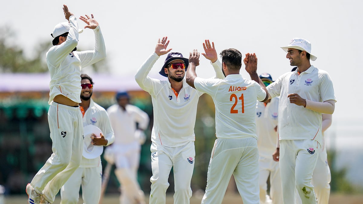 PTI : Jammu and Kashmirs Auqib Nabi celebrates with teammates after taking the wicket of Karnatakas Smaran Ravichandran during the third day of the Ranji Trophy 2025-26 final at the KSCA Cricket Stadium.