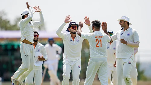 PTI : Jammu and Kashmirs Auqib Nabi celebrates with teammates after taking the wicket of Karnatakas Smaran Ravichandran during the third day of the Ranji Trophy 2025-26 final at the KSCA Cricket Stadium.