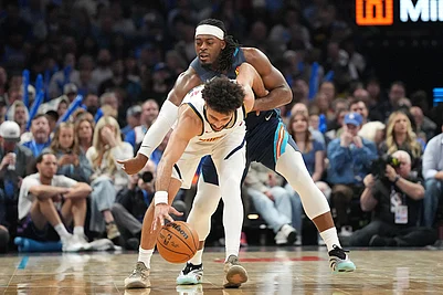 | Photo: AP/Kyle Phillips : Oklahoma City Thunder guard Luguentz Dort, back, tries to steal the ball from Denver Nuggets guard Jamal Murray during the second half of an NBA basketball game in Oklahoma City.