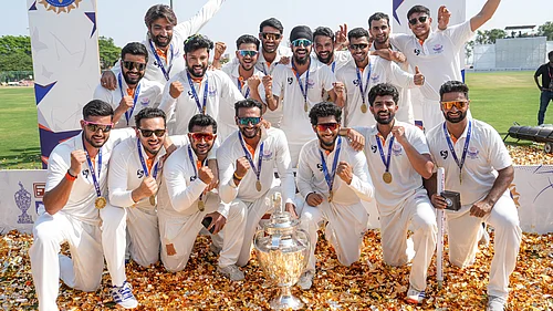 PTI : Jammu and Kashmir players pose with the trophy after the teams victory in the Ranji Trophy 2025-26 final against Karnataka, at KSCA Stadium in Hubballi.