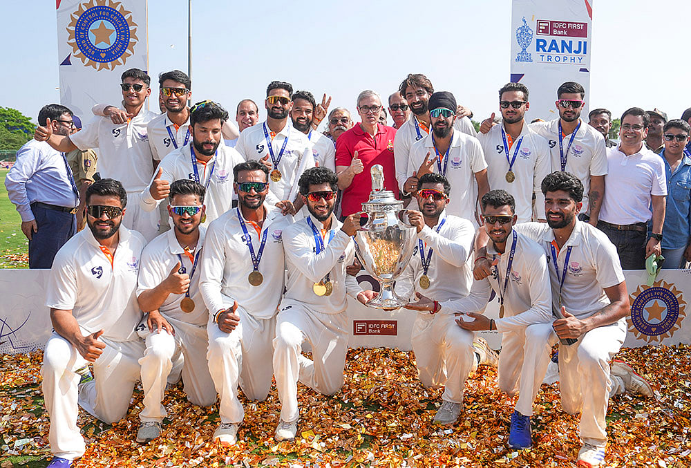 | Photo: PTI/Shailendra Bhojak : Jammu and Kashmir Chief Minister Omar Abdullah poses with players during the felicitation ceremony after the teams victory in the Ranji Trophy 2025-26 final cricket match against Karnataka, at KSCA Stadium, in Hubballi, Karnataka.