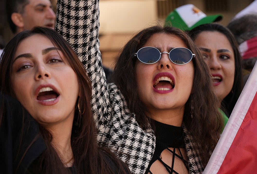 | Photo: AP/Hiro Komae : Iranians living in Japan and their families gather near the Iranian Embassy in Tokyo to show support Saturdays U.S.-Israel strikes on Iran. 