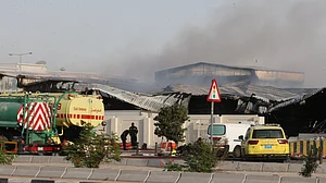 | Photo: AP : Firefighters work as smoke rises outside a damaged warehouse in an industrial area in Al Rayyan, Qatar, following an Iranian strike, Sunday, March 1, 2026.
