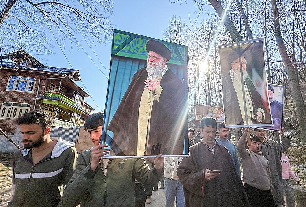 | Photo: PTI : People hold a portrait of Irans Supreme Leader Ayatollah Ali Khamenei during a protest following his alleged killing in a US-Israel strike, in Kulgam.