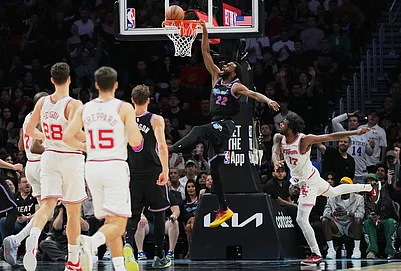 | Photo: AP/Lynne Sladky : Miami Heat forward Andrew Wiggins (22) dunks over Houston Rockets forward Tari Eason (17) during the second half of an NBA basketball game, in Miami.