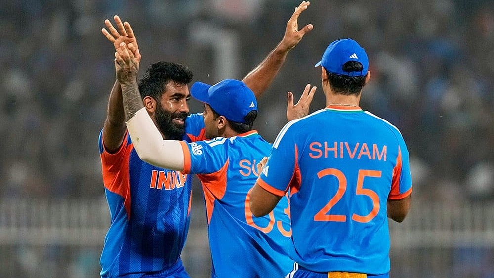 | Photo: AP/Bikas Das : Indias Jasprit Bumrah, left, celebrates with captain Suryakumar Yadav the wicket of West Indies Roston Chase during the T20 World Cup cricket match between India and West Indies in Kolkata.