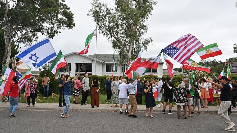 | Photo: Mick Tsikas/AAP Image via AP : Iranian Australians react outside Iran's embassy in Canberra, Australia.
