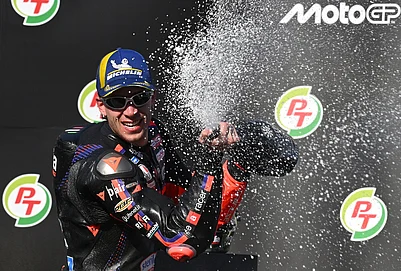 | Photo: AP/Kittinun Rodsupan : MotoGP winner Italys rider Marco Bezzecchi, celebrates on the podium after the MotoGP at the Chang International Circuit in Buriram, Thailand.