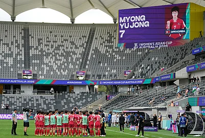 | Photo: AP/Rick Rycroft : North Korean players gather following the Womens Asia Cup soccer match between North Korea and Uzbekistan in Sydney.