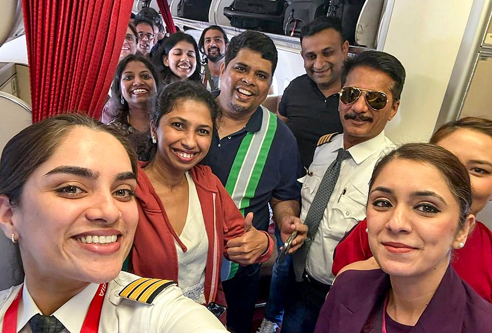 | Photo: @AirIndia_News/X via PTI  : Passengers and crew of Air India flight AI916D from Dubai arrive at the Indira Gandhi International Airport, in New Delhi. The airline said the flight was the first by an Indian carrier to land in the national capital amid the ongoing conflict in the Middle East. 