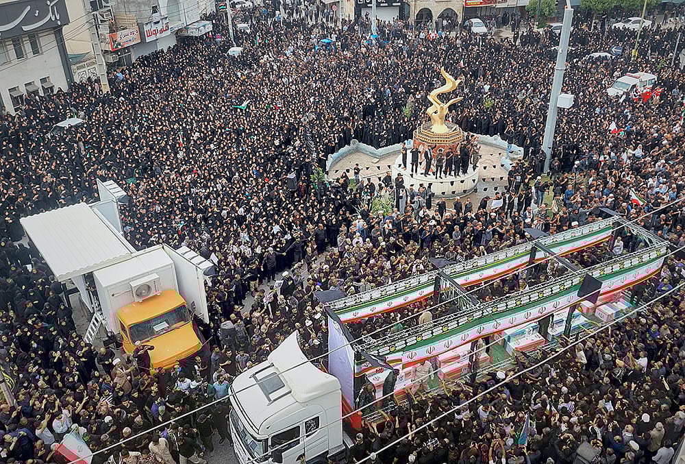 | Photo: Abbas Zakeri/Mehr News Agency via AP : Residents and officials attend the funeral of people killed in what Iranian officials said was an Israeli-U.S. strike Feb. 28 on a girls elementary school in Minab, Iran.