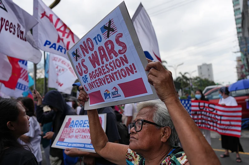 AP : Protesters hold slogans during a rally in solidarity with Iran after they were blocked by police as they marched towards the U.S. embassy in Manila, Philippines on Tuesday, March 3, 2026.