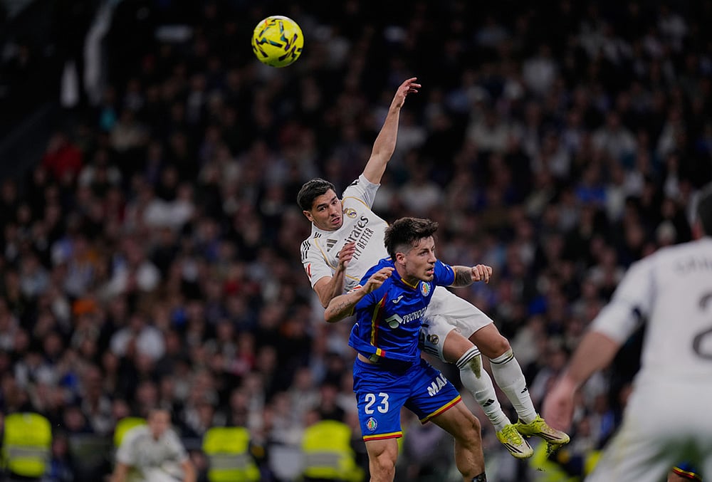 | Photo: AP/Manu Fernandez : Getafe's Adrian Liso jumps for the ball against Real Madrid's Brahim Diaz during a Spanish La Liga soccer match between Real Madrid and Getafe in Madrid, Spain.