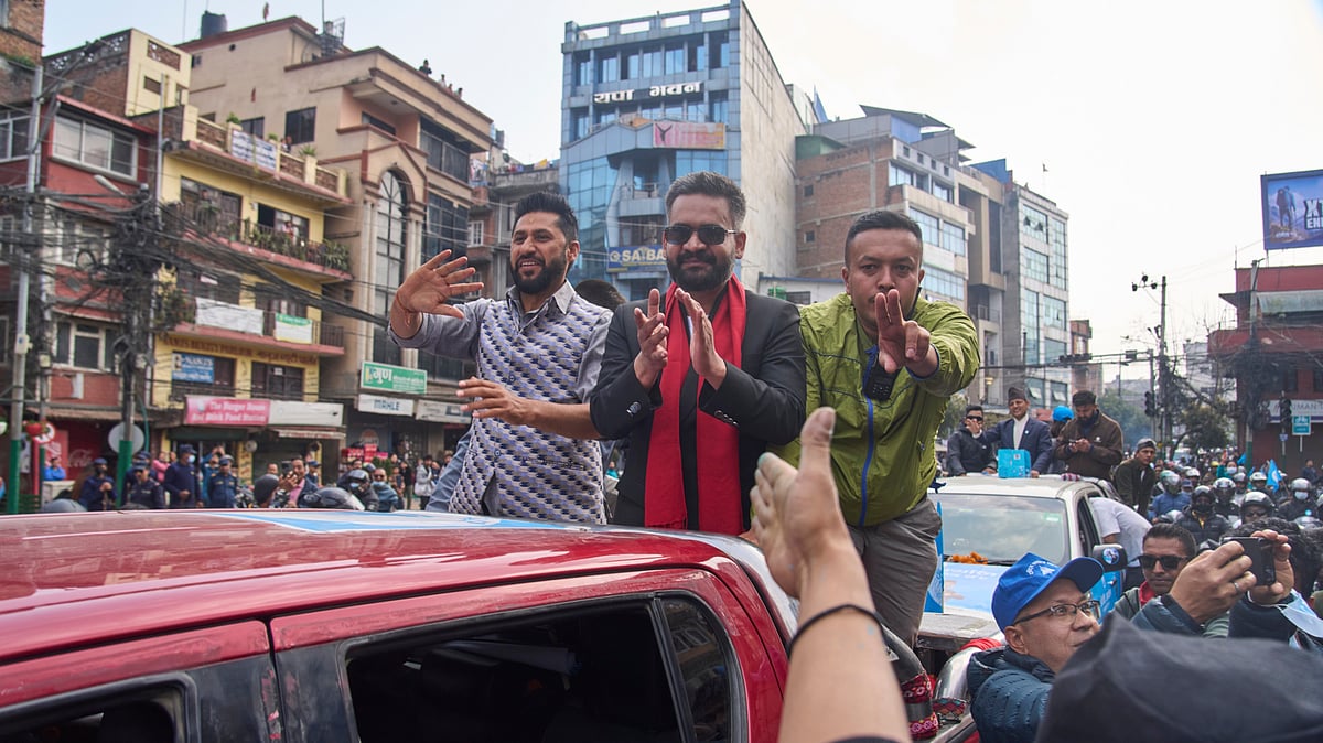 Photo: AP : Balendra Shah, center, former mayor of Kathmandu Metropolitan City and prime ministerial candidate of the Rastriya Swatantra Party, joins Rabi Lamichhane, left, the partys president, during an election campaign rally in Lalitpur, Nepal, Saturday, Feb. 28, 2026.