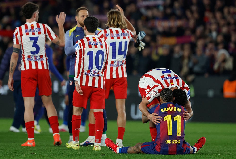 | Photo: AP/Joan Monfort : Atletico Madrids Johnny Cardoso hugs Barcelonas Raphinha after during the Copa del Rey semifinal second leg soccer match between Barcelona and Atletico Madrid in Barcelona, Spain.