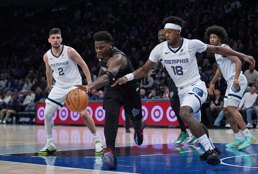 | Photo: AP/Abbie Parr : Minnesota Timberwolves guard Anthony Edwards, middle, reaches for the ball against Memphis Grizzlies forward Olivier-Maxence Prosper (18) during the first half of an NBA basketball game in Minneapolis. 