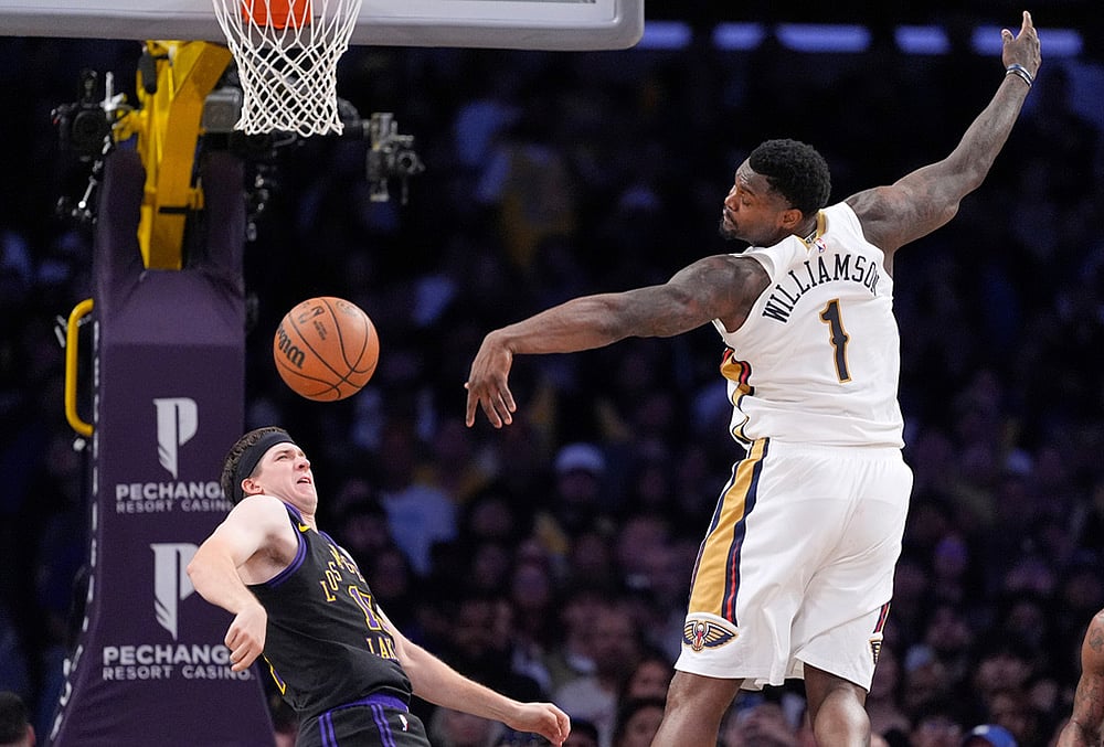 |  Photo: AP/Mark J. Terrill : New Orleans Pelicans forward Zion Williamson, right, looses control of the ball as Los Angeles Lakers guard Austin Reaves defends during the second half of an NBA basketball game in Los Angeles. 
