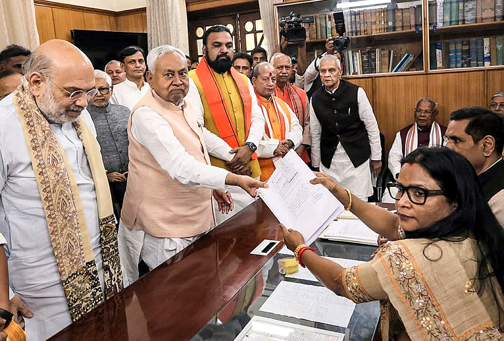 | Photo: Handout via PTI  : Bihar Chief Minister Nitish Kumar in the presence of Union Home Minister Amit Shah files nomination papers for the Rajya Sabha polls, in Patna. State Deputy Chief Ministers Samrat Choudhary and Vijay Kumar Sinha also seen. 