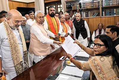 | Photo: Handout via PTI : Bihar Chief Minister Nitish Kumar in the presence of Union Home Minister Amit Shah files nomination papers for the Rajya Sabha polls, in Patna. State Deputy Chief Ministers Samrat Choudhary and Vijay Kumar Sinha also seen.