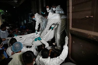 | Photo: AP/Eranga Jayawardena : Healthcare workers unload the bodies of Iranian sailors from a vehicle who died when their IRIS Dena warship sank outside Sri Lankas territorial waters, in Galle, Sri Lanka.