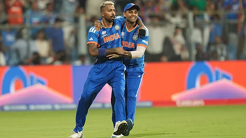 (AP Photo/Rafiq Maqbool) : Indias Hardik Pandya, left, celebrates with captain Suryakumar Yadav after the dismissal of Englands Phil Salt during the T20 World Cup cricket semi-final match between India and England in Mumbai, India, Thursday, March 5, 2026
