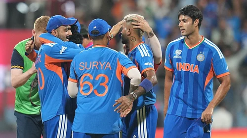 AP Photo/Rafiq Maqbool : Indian players celebrate after their win in the T20 World Cup cricket semi-final match against England in Mumbai, India, Thursday, March 5, 2026.
