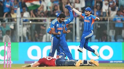 (AP Photo/Rafiq Maqbool) : Indias Jasprit Bumrah, left, and teammates celebrate the run out of Englands Jacob Bethell, on ground, during the T20 World Cup cricket semi-final match between India and England in Mumbai, India, Thursday, March 5, 2026.