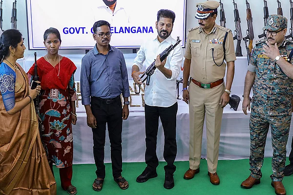 | Photo: PTI : Representative image: Telangana Chief Minister Revanth Reddy looks at a weapon after as many as 130 Maoists surrendered before him, in Hyderabad.