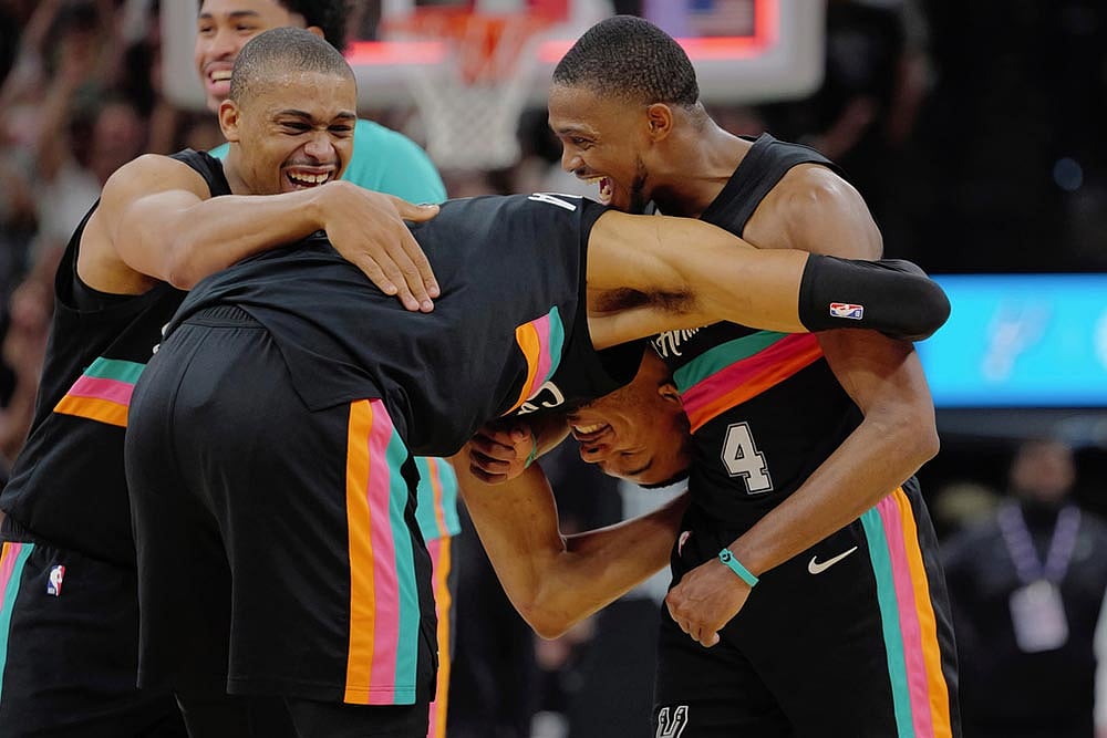 | Photo: AP/Darren Abate : San Antonio Spurs players Victor Wembanyama, center, DeAaron Fox (4) and Keldon Johnson celebrate their win after an NBA basketball game against the Los Angeles Clippers in San Antonio.